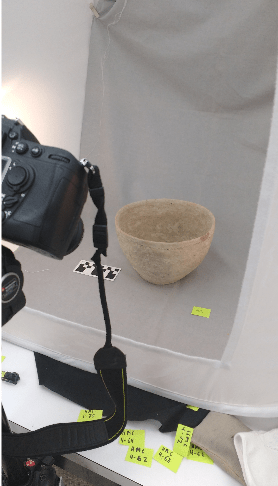 Figure 5. Photographing a Bab-edh Drah Tomb Pot during Winter Term